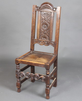 A Victorian 17th Century style hall chair with carved panel to the back, solid seat, raised on turned and block supports 