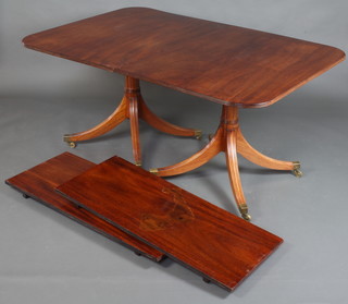 A Georgian style mahogany twin pillar extending dining table raised on turned column and tripod base with 2 extra leaves 72cm h x 107cm w x 157cm l x 247cm l when extended 