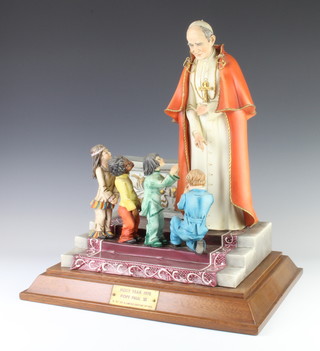 A limited edition Capodimonte figure group - Papal Blessing Pope Paul VI Commemorating Holy Year 1975 no.52 of 200, raised on a wooden plinth 43cm 