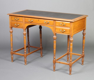 A 19th Century French walnut writing table with inset black writing surface above 1 long and 4 short drawers, raised on cup and cover supports with box framed stretcher 76cm h x 107cm w x 51cm d 