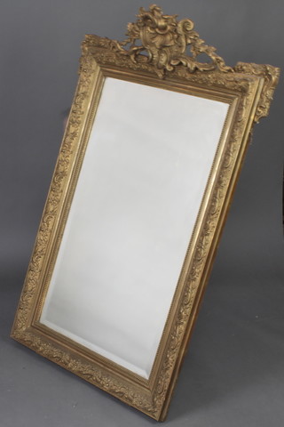 A 19th Century rectangular bevelled plate wall mirror contained in a decorative gilt frame 140cm x 88cm 