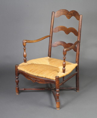 A 19th Century French elm ladder back open arm carver chair with woven rush seat on turned supports with X framed stretcher 