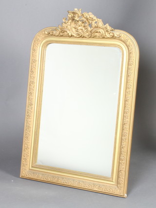 A 19th Century arch shaped plate mirror contained in a decorative gilt frame with swag crest 117cm h x 78cm w 