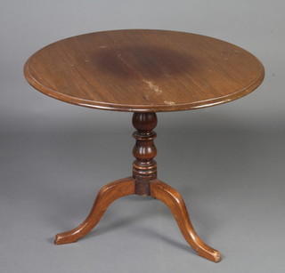A 19th Century circular mahogany snap top tea table, raised on baluster turned column and tripod base 71cm h x 87cm diam. 