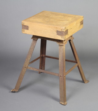 A square pine butcher's block raised on an associated iron stand with outswept supports 74cm h x 45cm x 45cm 