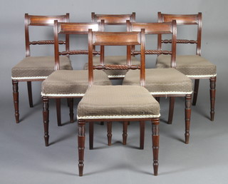 A set of 6 Regency mahogany bar back dining chairs with rope turned mid rails and over stuffed seats, raised on turned supports 
