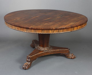 A William IV circular rosewood snap top breakfast table raised on a chamfered turned column and triform base with paw feet (complete with bolts) 73cm h x 134cm diam. 