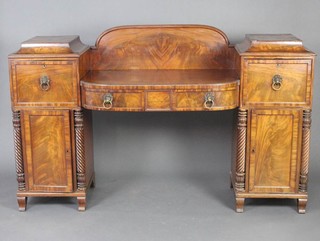 A Regency mahogany drop pedestal sideboard, the pedestals fitted a cupboard above cupboard and drawer above cupboard and turned columns to the sides, the centre section with raised back fitted 2 short drawers 113cm h  