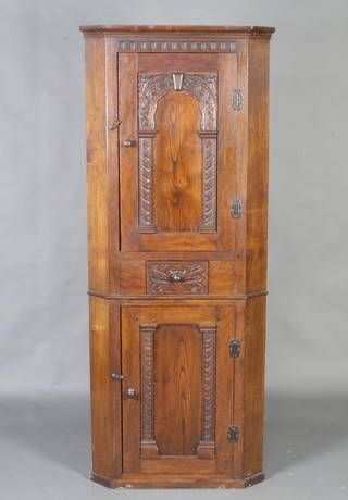 A carved oak double corner cabinet, the upper section with moulded cornice and arcaded decoration enclosed by carved arch panelled door, fitted a drawer above a panelled door 175cm h x 71cm w x 43cm d 