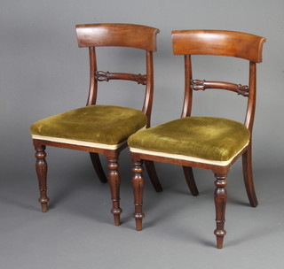 A pair of 19th Century mahogany bar back dining chairs with shaped mid rail and over stuffed seats, raised on turned supports 