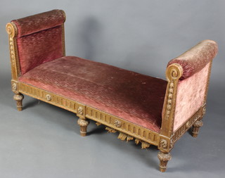 An Empire style carved wood and gilt painted window seat upholstered in red material 82cm h x 153cm w x 65cm d 