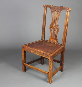 A 19th Century carved oak hall chair with pierced vase shaped slat back and solid seat, raised on square supports