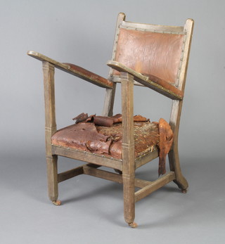 A Macintosh style Arts and Crafts oak open arm chair of joined construction, the seat and back upholstered leather 