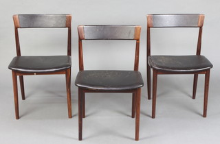 Heales, mid 20th Century, a set of three Danish Henry Rosengren Hansen bar back rosewood dining chairs, the seats and backs upholstered in rexine, raised on turned supports. Cites certificate reference