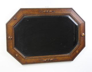 A 1930's octagonal bevelled plate hall mirror contained in an oak frame 67cm x 52cm 