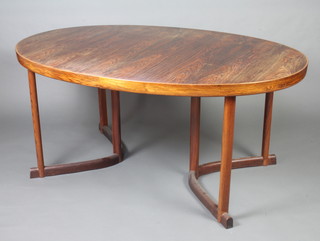 A Danish mid 20th Century rosewood oval extending dining table with 2 extra leaves, raised on square supports with U shaped base 73cm h x 108cm w 162cm l  x 273cm l when extended 