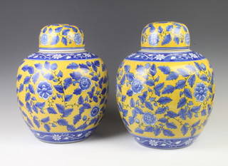 A pair of modern Chinese yellow ground vases and covers decorated flowers 35cm