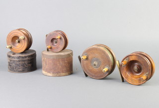A wooden Starback centre pin 2 1/2" fishing reel, contained in a metal case, 1 other Starback 4 1/2" centre pin mahogany and brass fishing reel and 2 wooden centre pin reels   