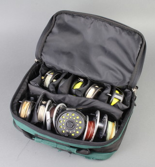 A Sportsfish canvas fishing reel case containing 2 Rimfly fly fishing reels, a Leeda fly reel, a Shakespeare Pflueger medallist centrepin reel, a Shakespeare Alpha 2528 reel, a Ganat reel, a fly reel no.2049 and an Adder reel together with various spools 
