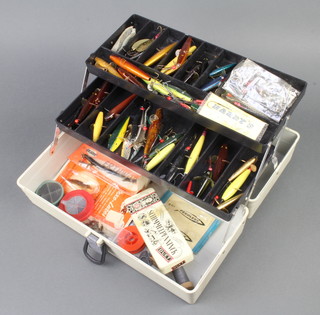 A plastic cantilever box containing a collection of Hardy and other vintage fishing lures and bait mounts
 