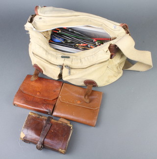 A Brady canvas and leather fishing tackle bag containing leather Army & Navy fly wallet, two other fly wallets, a box of approx. 50 fishing floats, hooks, etc, etc 