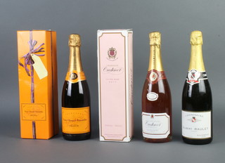 A bottle of Veuve Clicquot Ponsardin champagne boxed,  bottle of Oudinot rose champagne boxed and a bottle of Gilbert Raulet champagne 