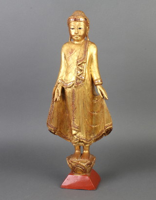 A gilt painted carved wooden figure of standing Buddha 44cm h x 10cm w x 9cm d 