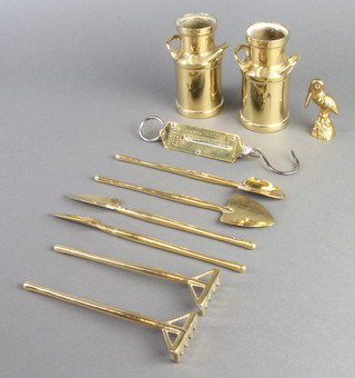 A pair of brass twin handled milk churns 4cm x 2cm, a Hughes pocket spring balance, 2 Continental style miniature brass spades, two ditto rakes and two ditto dibbers 
