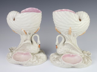 A pair of Victorian Royal Worcester centre pieces in the form of shells supported by swans on floral bases 19cm 