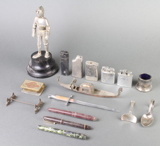 A Swiss paper knife in the form of a bayonet, the 14cm blade marked Pauroux FR Chexbres, a brass match slip, childs spoon and pusher, table lighter in the form of a standing knight and other minor curios 