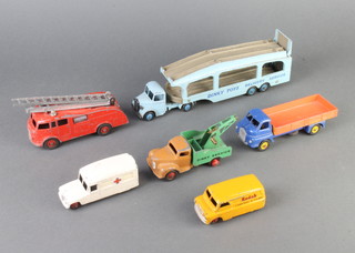 A Dinky no.480 Kodak Bedford delivery van (chips to paint), a Dinky 555 fire engine, Dinky 255 Big Bedford van, Dinky no.582 Pullmore car transporter, Dinky Daimler ambulance and a Dinky model Commer breakdown van (all play worn)  