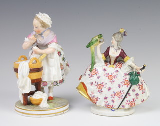 A German figure of a lady holding a parrot in her hand 13cm, ditto of a washer woman on a round base 15cm 