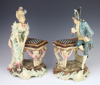 A pair of Continental Majolica figures with lady and gentleman chess players raised on rococo bases 37cm