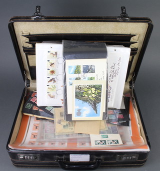 A briefcase containing GB first day covers and lose world stamps 