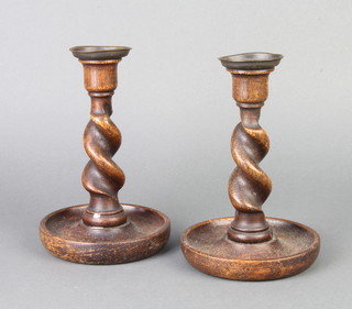A pair of 1930's spiral turned oak candlesticks with metal sconces 18cm x 10cm 