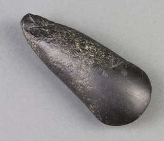 A stone axe head 10cm x 4cm 