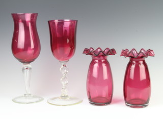 A pair of Victorian style cranberry glass vases with wavy rims 17cm, a similar glass and vase 