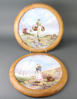 A pair of early 20th Century Dutch circular porcelain plaques decorated with ladies in a coastal setting 36cm 
