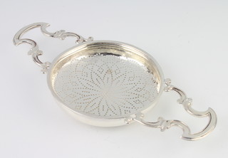 A Georgian silver strainer with scroll handles and geometric decoration, maker IWTB, 96 grams 