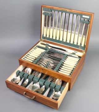 A canteen of cutlery for 8 contained in a crossbanded walnut canteen 