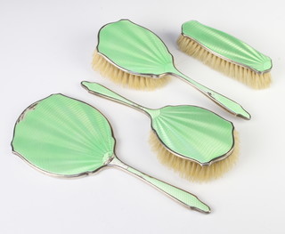 A 4 piece silver and enamel dressing table set comprising hand mirror, 2 hair brushes, 1 clothes brush, Birmingham 1932 