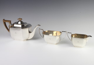 An octagonal silver 3 piece tea set with fruitwood handles comprising teapot, sugar basin and milk jug, Edinburgh 1928, maker Hamilton and Inches, 1245 grams gross 