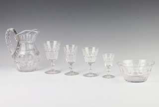 A suite of cut glass table glassware comprising 9 liqueur glasses, 13 sherry glasses, 13 small wines, 5 medium wines and 11 large wine glasses, together with 6 dessert bowls and 2 jugs 