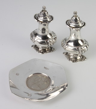 A pair of Victorian repousse silver pepperettes Birmingham 1900 and a hexagonal coin set dish  Birmingham 1973 
