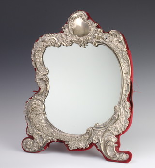 A Victorian repousse silver rococo style easel mirror with vacant cartouche, decorated with angels, flowers and birds, London 1896, 40cm 