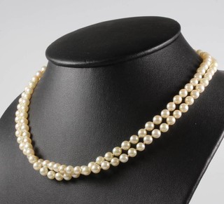 A double string of cultured pearls with a 9ct yellow gold pearl set clasp 43cm 