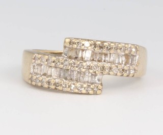 A 9ct yellow gold baguette diamond crossover ring size M, 3.3 grams 
