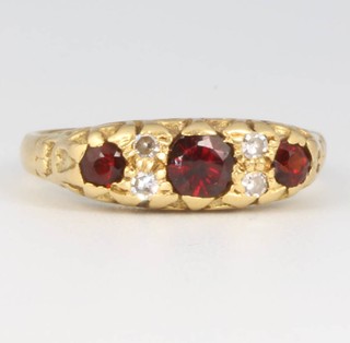 An 18ct yellow gold garnet and diamond ring, size L 1/2, 4.5 grams