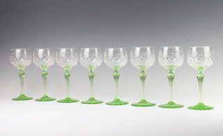 A set of 8 small hock wine glasses with green stems 18cm 