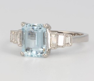 An Art Deco style platinum emerald cut aquamarine and diamond ring, the centre stone approx. 1.6ct flanked by 3 baguette cut diamonds approx. 0.3ct size M 
